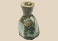 Ancient Roman green glass unguentarium with heavy iridescence and mineral deposits