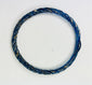 Ancient Roman cobalt-blue glass bracelet reflecting iridescent highlights under light.
