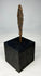 Side profile of ancient European iron weapon point displayed vertically