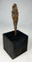 Early historic period iron arrowhead with tapered tang mounted on black wooden base