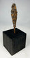 Early historic period iron arrowhead with tapered tang mounted on black wooden base