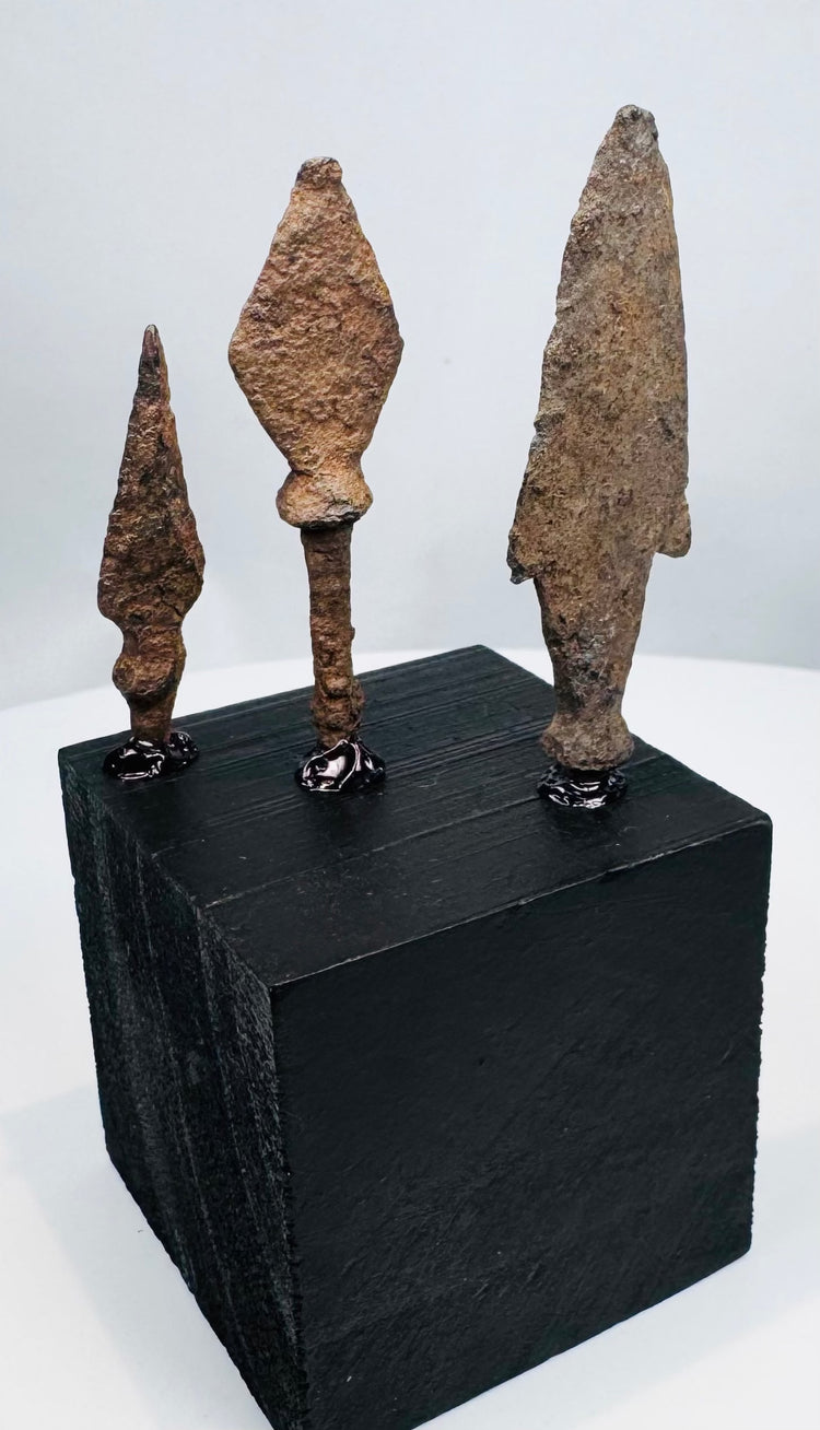 Three European iron weapon points in elongated, leaf-shaped, and triangular forms