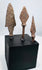 Elongated archaeological iron arrowhead with pronounced shoulders and surviving tang