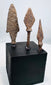 Elongated archaeological iron arrowhead with pronounced shoulders and surviving tang