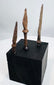 Small triangular hand-forged iron arrowhead with heavy mineral encrustation