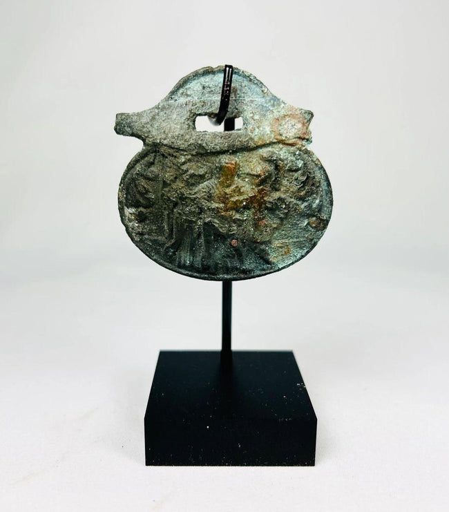 Ancient Roman bronze pendant with engraved soldier figures from the 1st–4th century CE.