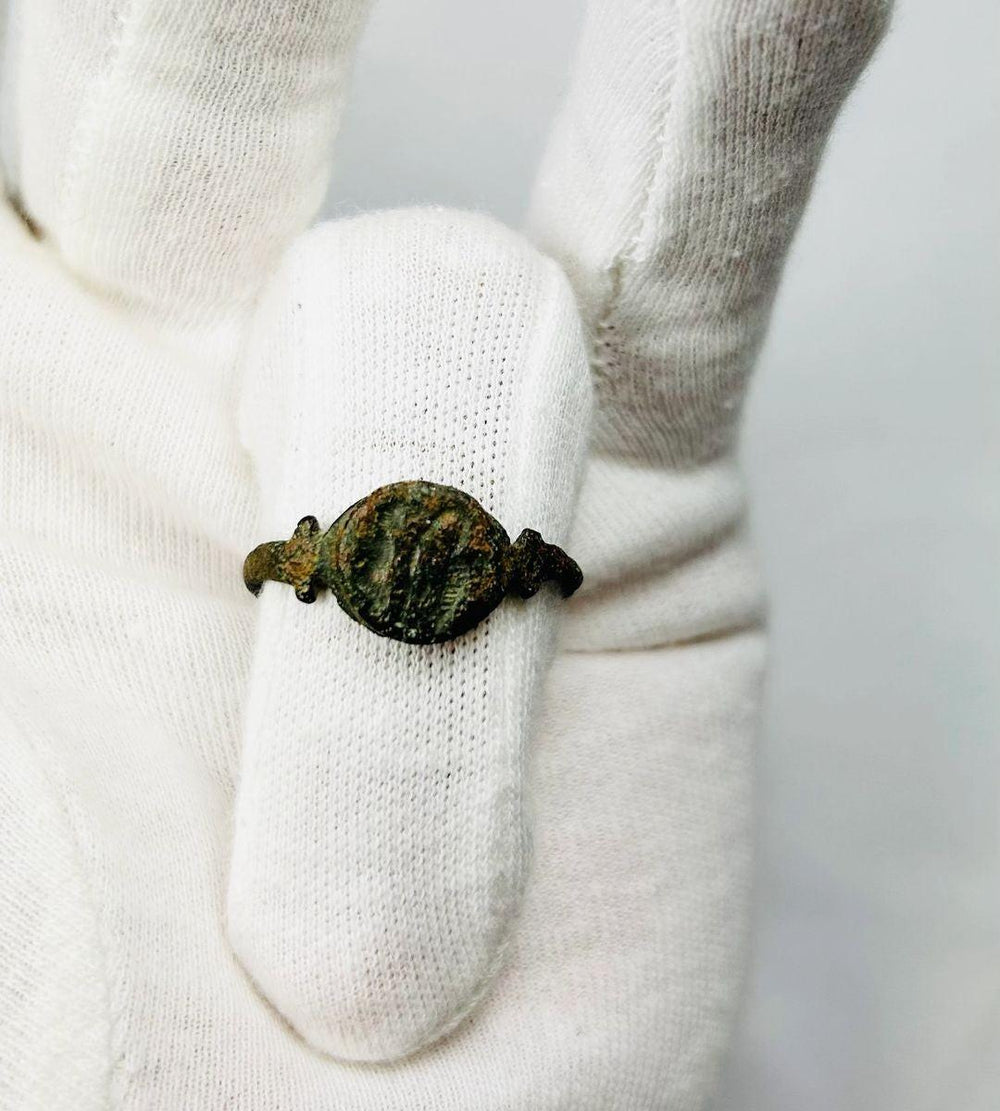 Ancient Roman cast bronze seal ring, 1st–3rd Century CE, featuring an engraved hippocampus on the bezel. Symbolic of Neptune and Roman maritime power, used as a personal seal and adornment. Developed patina reflects age and authenticity, with the bezel design well-preserved despite a broken band.