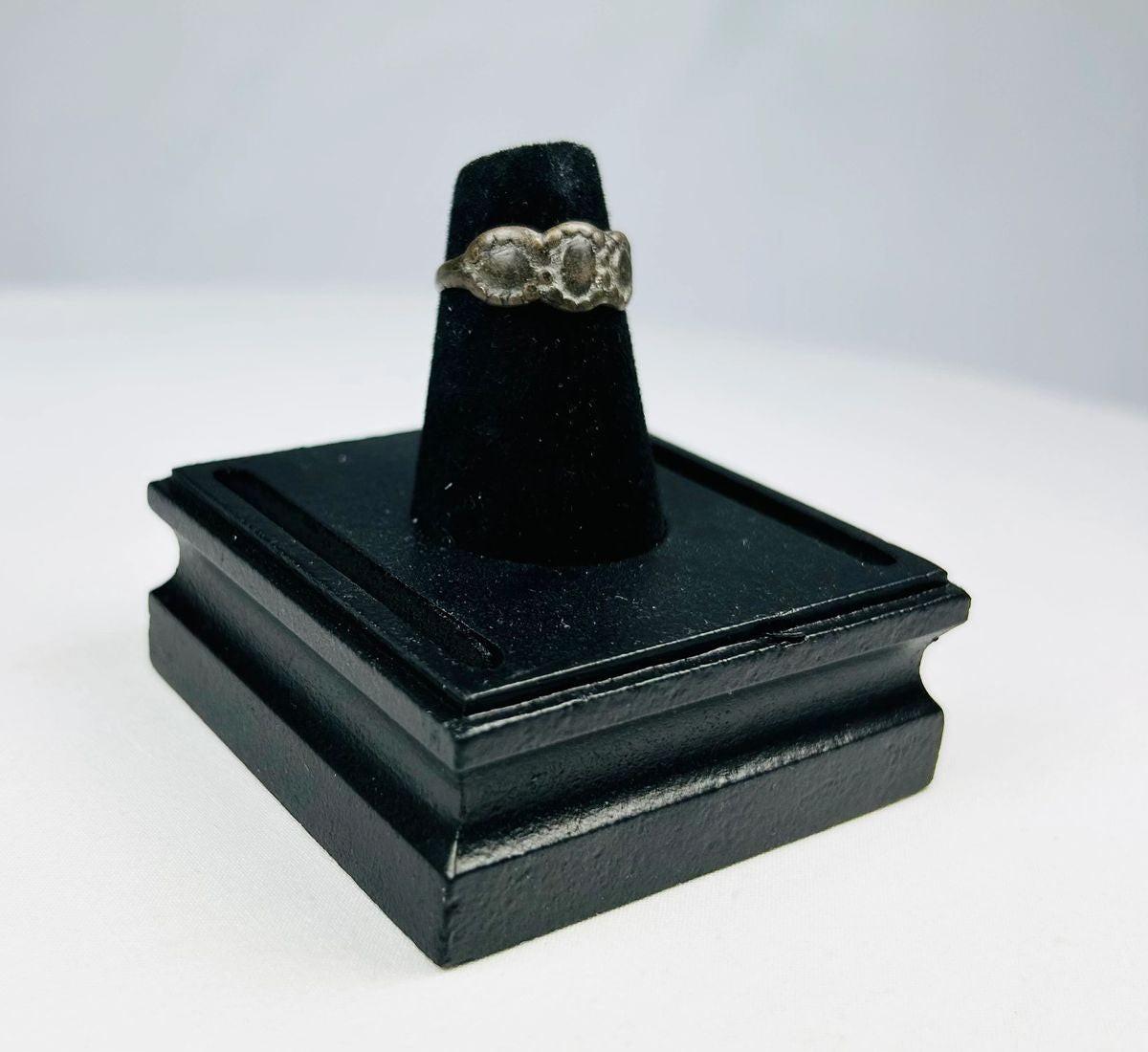 Ancient Late Roman–Byzantine silver ring featuring a clustered bezel of three oval motifs with natural aged patina, circa 300–600 CE.