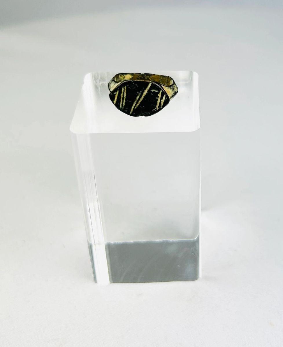 Ancient Roman bronze ring, circa 2nd century AD, featuring an engraved intaglio personal seal with geometric linear design; worn patina and age-related surface wear highlight its use as a functional signet ring within the Roman Empire.