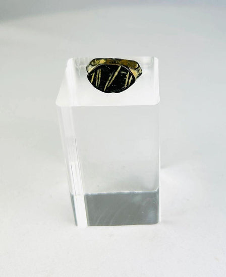 Ancient Roman bronze ring, circa 2nd century AD, featuring an engraved intaglio personal seal with geometric linear design; worn patina and age-related surface wear highlight its use as a functional signet ring within the Roman Empire.