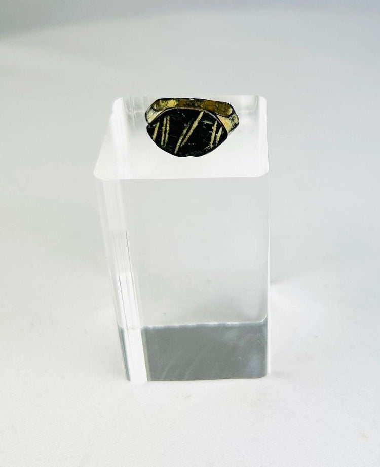 Ancient Roman bronze ring, circa 2nd century AD, featuring an engraved intaglio personal seal with geometric linear design; worn patina and age-related surface wear highlight its use as a functional signet ring within the Roman Empire.