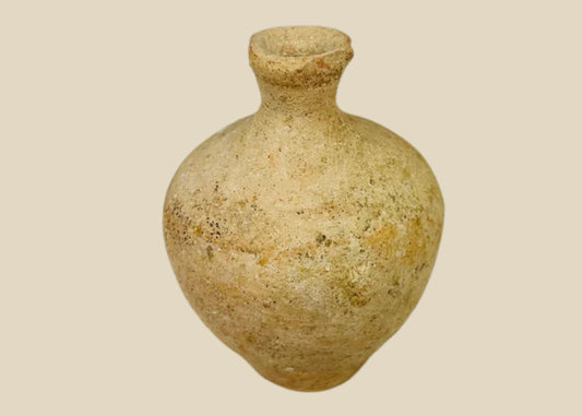 Roman terracotta juglet, 1st–3rd century CE, with rounded body, narrow neck, and flared rim, used for storing and pouring oils or perfumes, with natural aged patina.