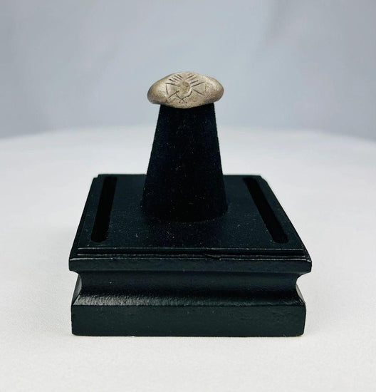 Ancient silver signet ring with finely engraved sunburst motif on bezel, thin rounded band, and natural aged patina, dating to the Late Roman to Early Byzantine period, circa 200–500 CE.