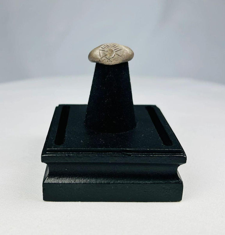 Ancient silver signet ring with finely engraved sunburst motif on bezel, thin rounded band, and natural aged patina, dating to the Late Roman to Early Byzantine period, circa 200–500 CE.