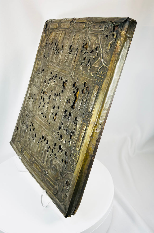 Russian icon with decorative metal riza and intricate religious storytelling scenes
