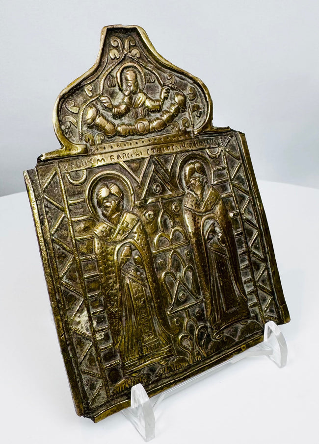 Cast bronze Russian Orthodox icon panel with geometric borders, religious figures, and aged dark patina.