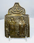 Nineteenth-century Russian Orthodox bronze folding icon center panel depicting two haloed saints and Christ above.