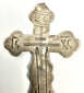 Close-up detail of engraved IC XC NC inscriptions on historic Russian Orthodox cross