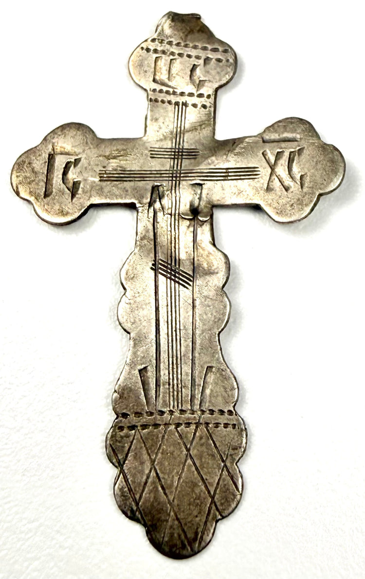 Frontal shot of antique silver pectoral cross with IC XC NC inscriptions and diamond grid