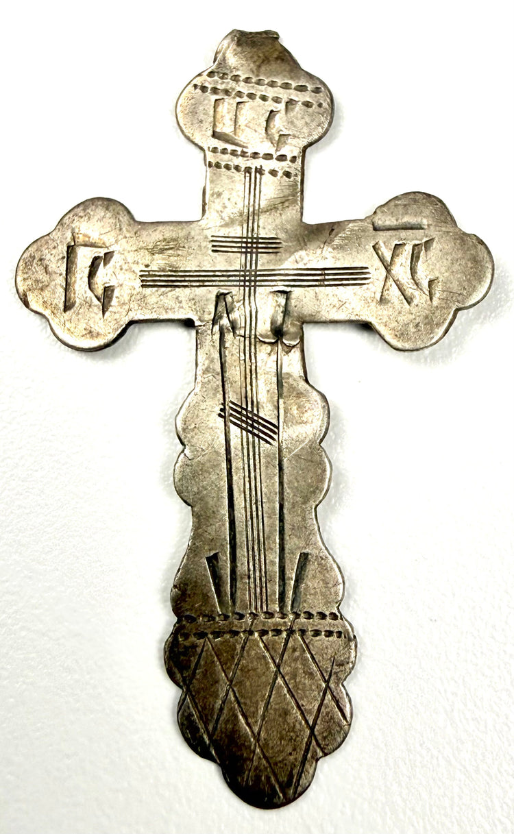 Full view of hand-engraved Russian Orthodox silver cross with scalloped trefoil terminals