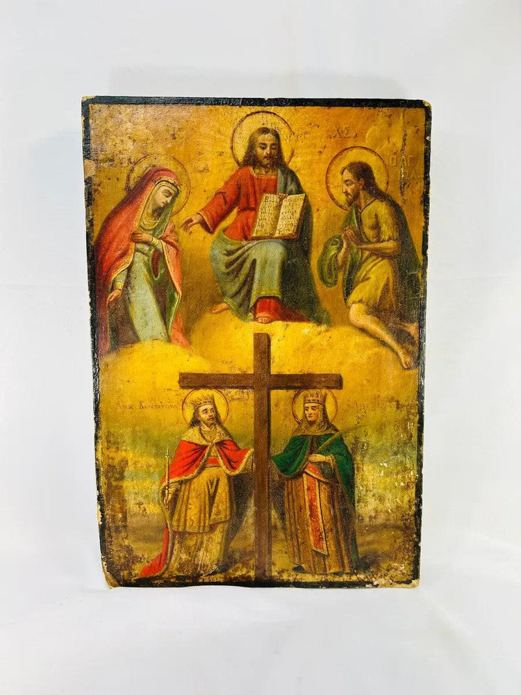 Antique Eastern Orthodox icon painted in tempera on wood, depicting Christ enthroned with Virgin Mary and St. John the Baptist above, and Saints Constantine and Helena venerating the True Cross below, photographed on a white background.