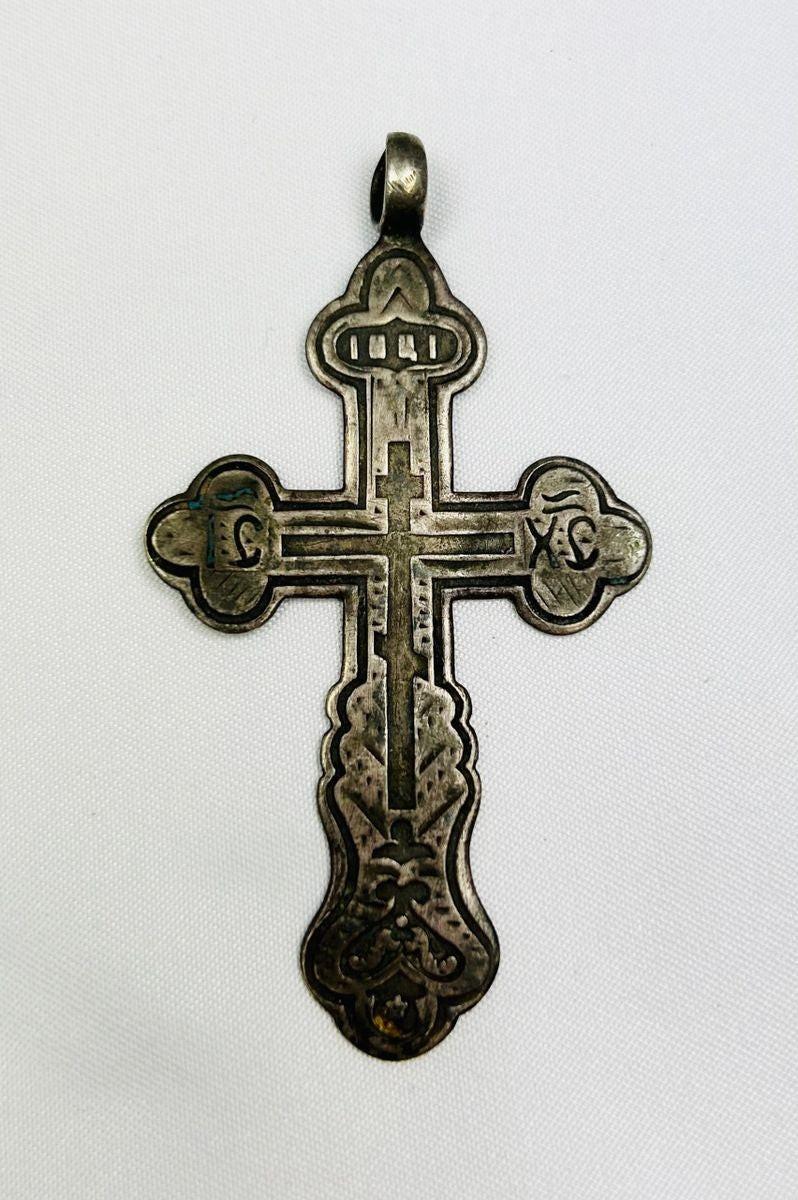 Antique Russian Orthodox silver cross pendant, 18th Century CE. Classic cruciform shape with additional upper crossbar and engraved Cyrillic inscriptions, including “IC XC” for Jesus Christ. Compact wearable devotional pendant with natural silver patina, reflecting Eastern Orthodox artistry, faith, and spiritual symbolism.
