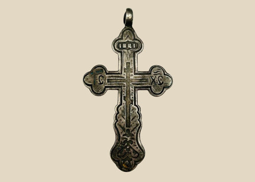 Antique Russian Orthodox silver cross pendant, 18th Century CE. Classic cruciform shape with additional upper crossbar and engraved Cyrillic inscriptions, including “IC XC” for Jesus Christ. Compact wearable devotional pendant with natural silver patina, reflecting Eastern Orthodox artistry, faith, and spiritual symbolism.