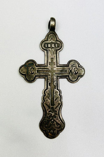 Antique Russian Orthodox silver cross pendant, 18th Century CE. Classic cruciform shape with additional upper crossbar and engraved Cyrillic inscriptions, including “IC XC” for Jesus Christ. Compact wearable devotional pendant with natural silver patina, reflecting Eastern Orthodox artistry, faith, and spiritual symbolism.