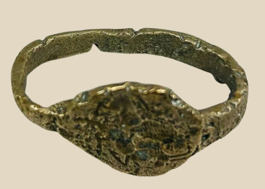 Ancient Sassanian bronze ring with engraved bezel depicting a lion and antelope predator-prey motif, symbolizing strength and balance, with rich green patina.