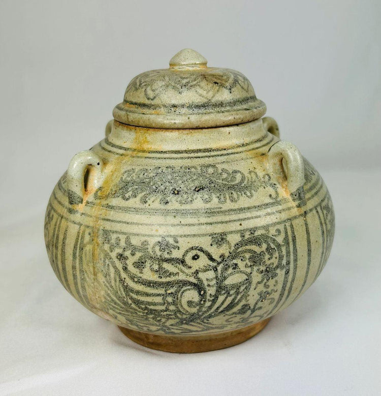 Sawankhalok glazed stoneware bowl from Thailand, 14th–16th century CE. Features dark underglaze decoration with birds, beasts, and floral motifs. Rounded form with smooth glaze, reflecting Sukhothai-era craftsmanship and Southeast Asian cultural influences. Excellent preserved condition with minor age wear.
