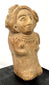 Ancient Mexican terracotta female figure with a broad flaring headdress, rounded body, and detailed ceremonial adornments.