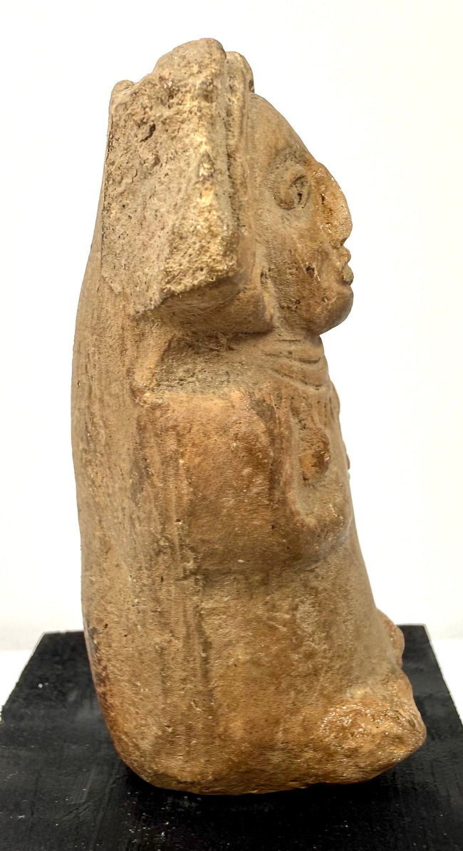 Side profile of Pre-Columbian terracotta seated woman with flaring headdress
