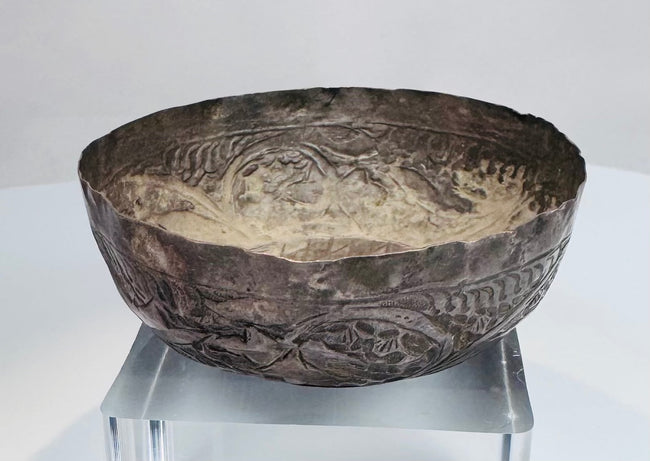 Engraved decoration on a 12th–13th century Seljuk silver bowl showing fine hand-worked patterns and historic surface wear.