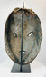Back view of a Sepik River wooden mask with attachment holes for adornments