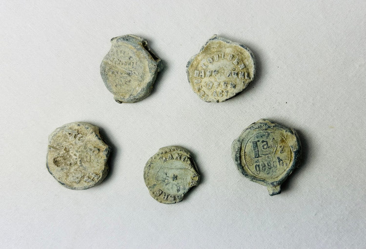 Shipwreck-recovered lead bag or bale seals with traces of impressed commercial markings
