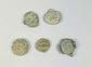 Marine-encrusted lead seals once used to identify bags and bales of traded goods