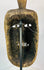 Rear view of a ceremonial wooden mask revealing tool marks and structural carving.