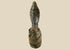 Hand-carved Central or West African wooden figure with elongated facial features, natural fiber torso wrapping, and traces of organic pigments, standing on a white background.