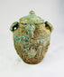 Shang–Zhou Dynasty bronze vessel, four-handled lidded jar with decorative relief patterns and aged patina, ancient Chinese ritual artifact.