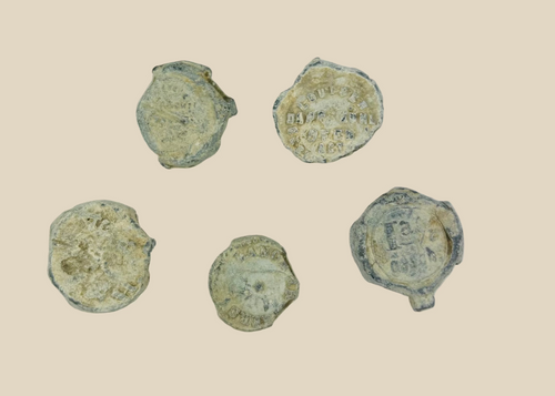 Set of five 18th–19th century English copper trade tokens recovered from shipwreck, heavily encrusted with marine patina, used in colonial trade and merchant commerce, historic maritime artifact
