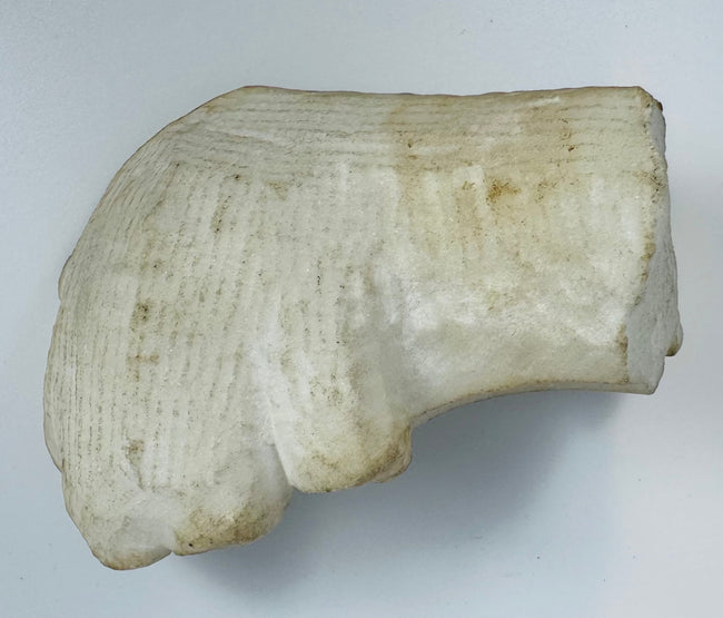 Fragment of a marble altar frame featuring ornate Baroque decoration and aged patina.
