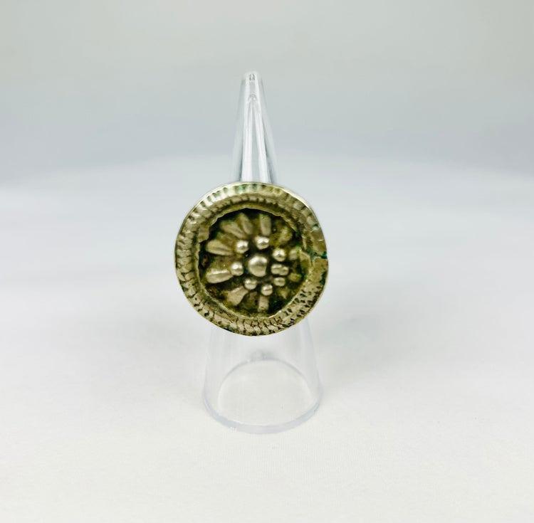 Antique Victorian-era ring featuring a floral rosette design and beaded border.