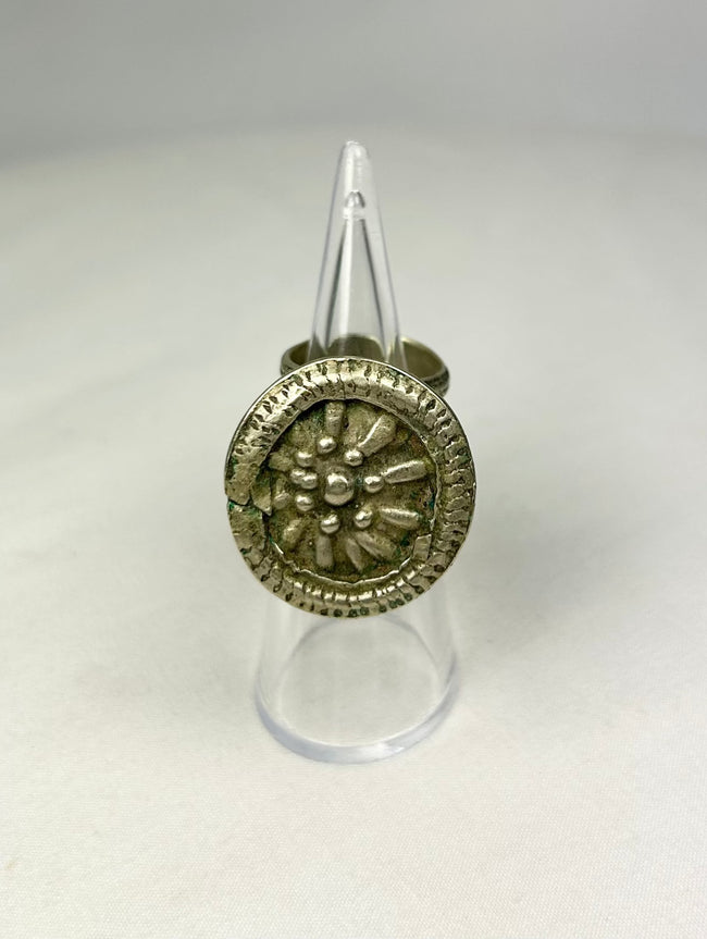 Antique Victorian silver ring featuring a beaded border surrounding a central rosette.