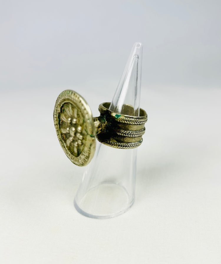 Victorian silver ring with raised floral rosette and intricate beaded edging.