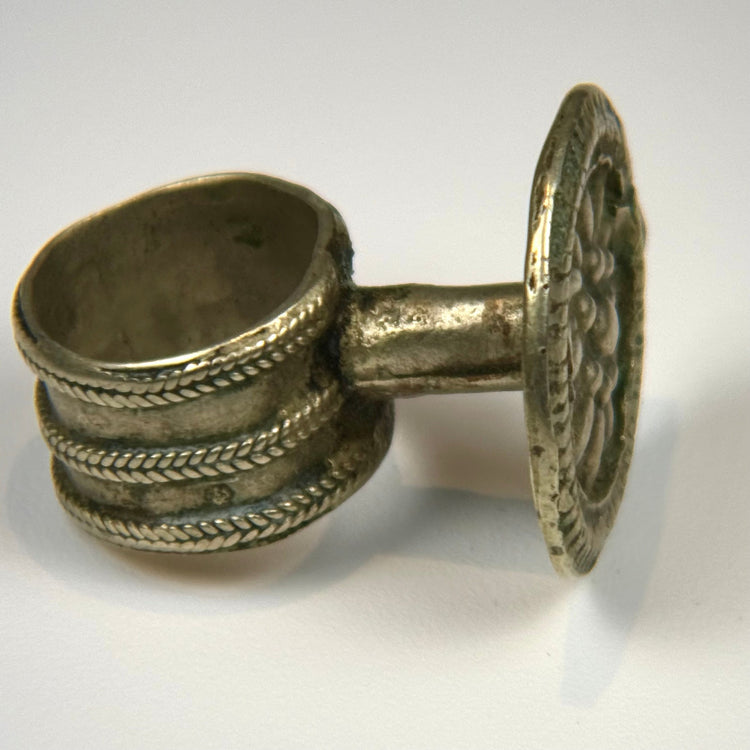 Silver alloy ring with round rosette bezel, ornamental beading, and intact wearable band