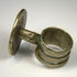 Victorian silver-toned ring with prominent round bezel and detailed floral relief decoration