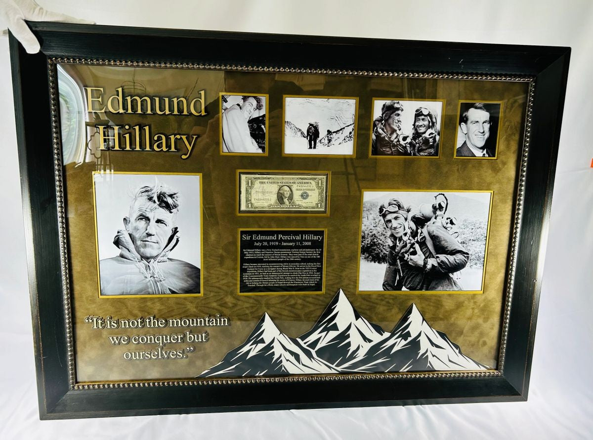 Framed display of Sir Edmund Hillary’s authentic signature on a US $1 banknote, professionally mounted with archival backing and glass, including photographic and illustrative elements commemorating his Everest ascent.
