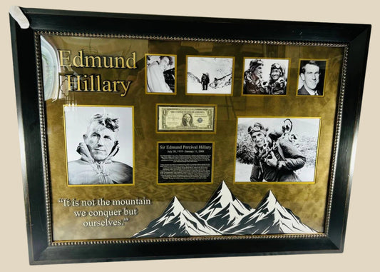 Framed display of Sir Edmund Hillary’s authentic signature on a US $1 banknote, professionally mounted with archival backing and glass, including photographic and illustrative elements commemorating his Everest ascent.