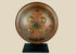 Small circular Indo-Persian Dhal shield, 11 inches diameter, lacquered black and red with damascened foliate motifs, four raised bosses, interior grips with knuckle-guard cushion, well-preserved antique.