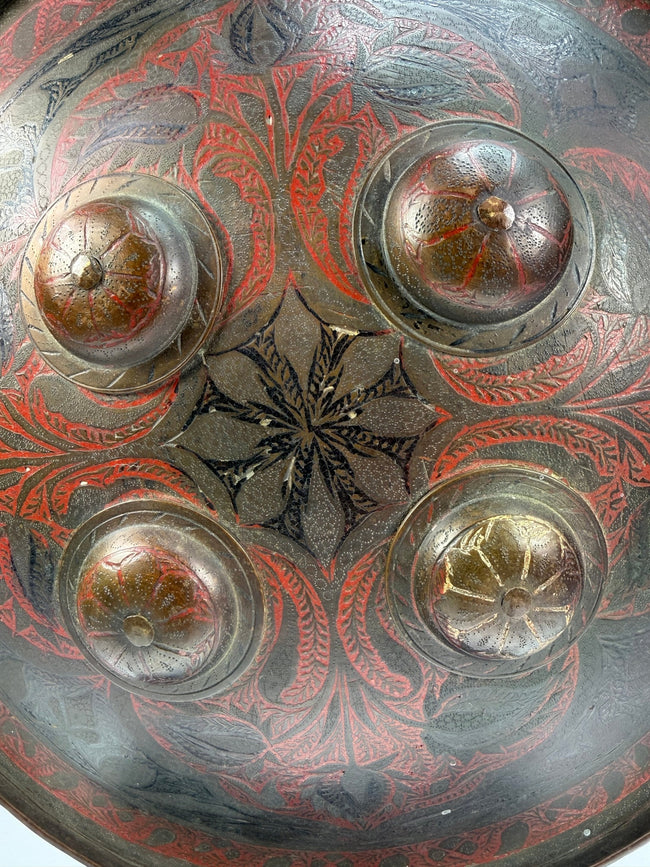 Indo-Persian Dhal shield in lacquered steel with red and black decoration and damascened foliate motifs